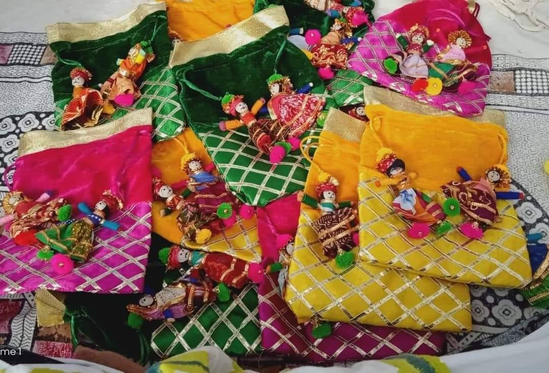 Handmade ethnic velvet potli pouch with decorative doll design