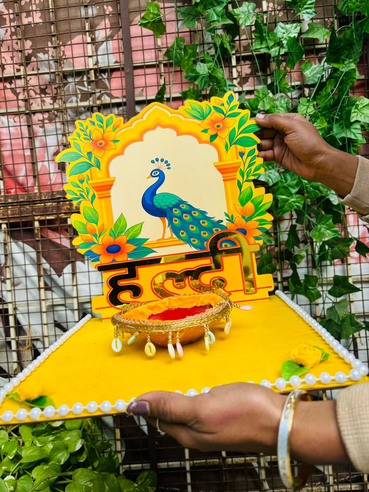 Designer bridal haldi platter with artistic peacock background for wedding ceremony