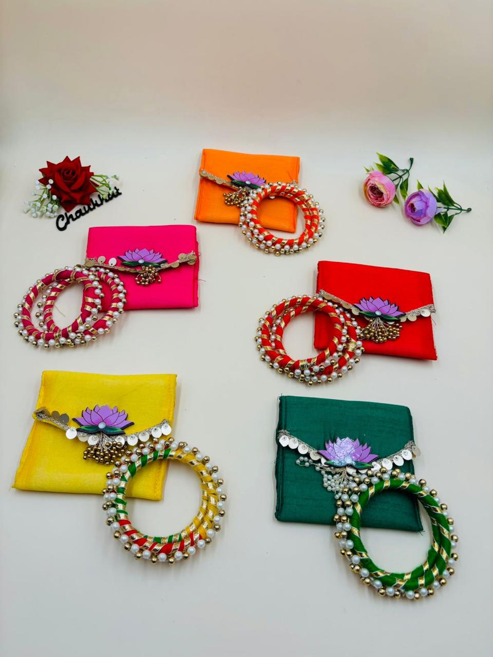 Pearl moti kangan bracelet with lotus design mini bag for festive wear