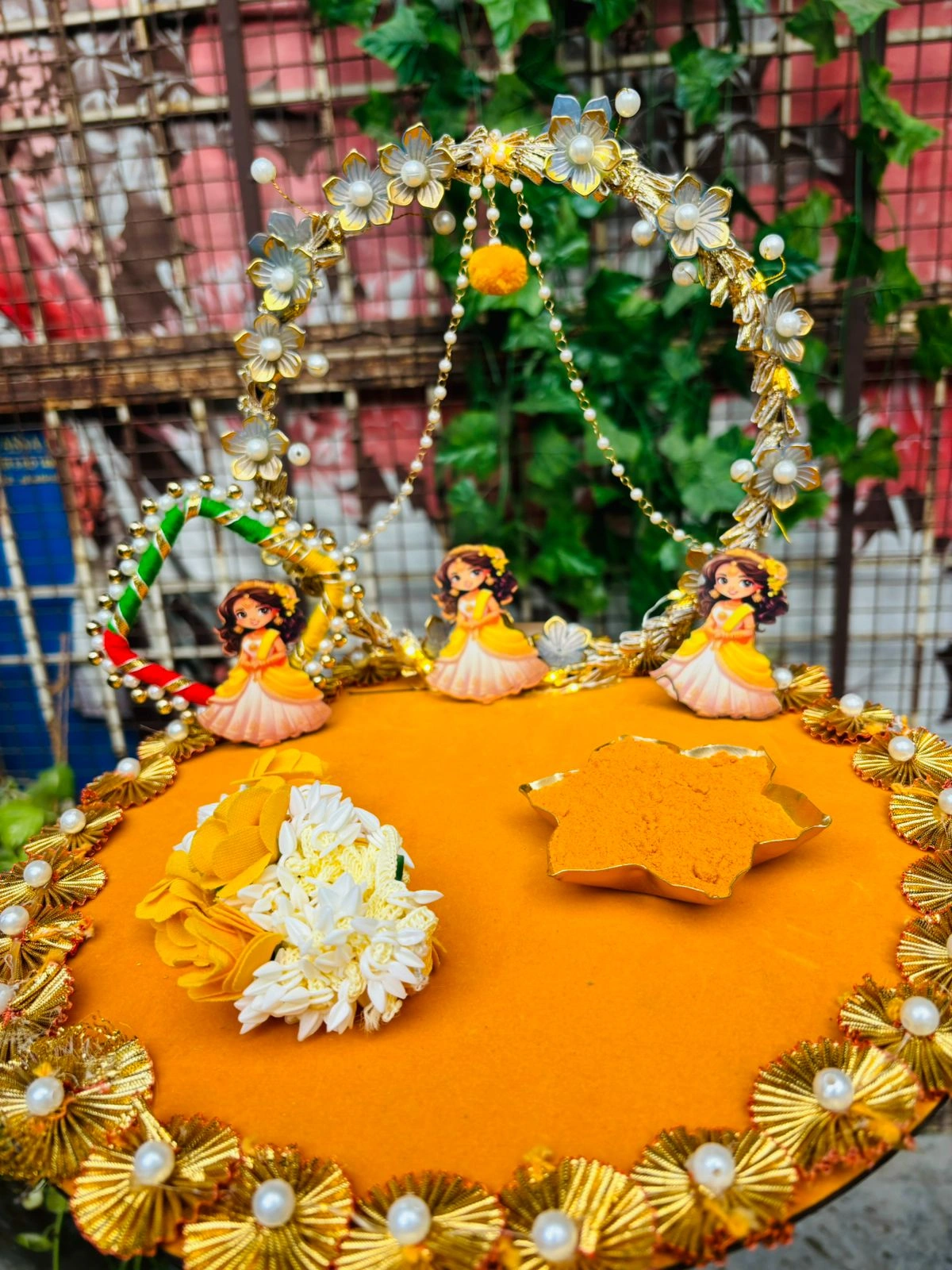 Designer haldi ceremony thali with floral ring and dolls