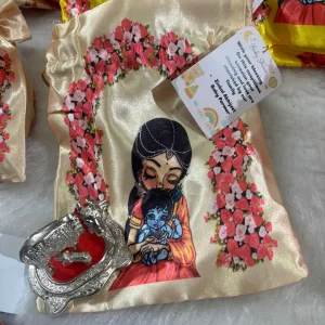 Baby shower gifting Yashoda Kanha potli with German silver cow and customized tag