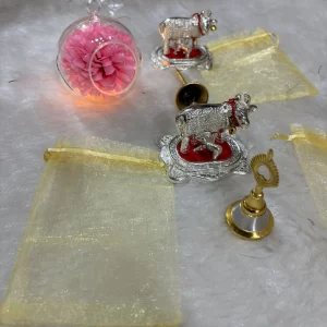 German silver cow and temple bell combo with decorative potli for pooja and gifting