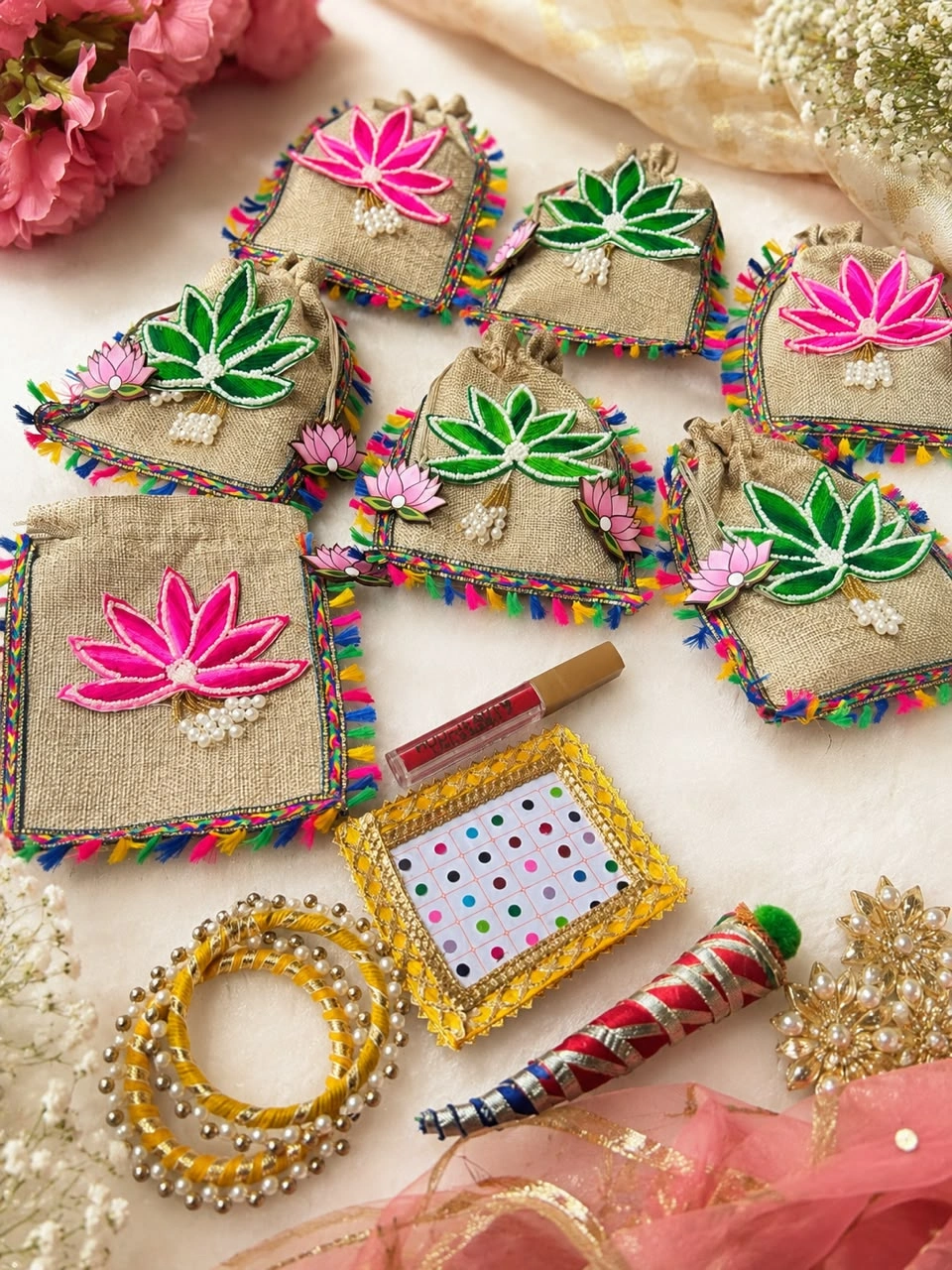 Hariyali Teej Festival Hamper featuring a premium potli bag, bangles, bindi, sindoor and mehndi gift set for women.